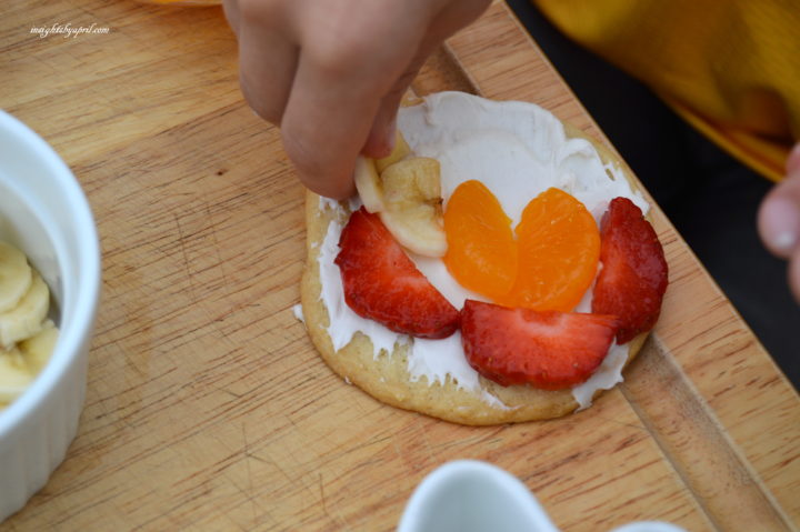 decorating rainbow fruit cookies