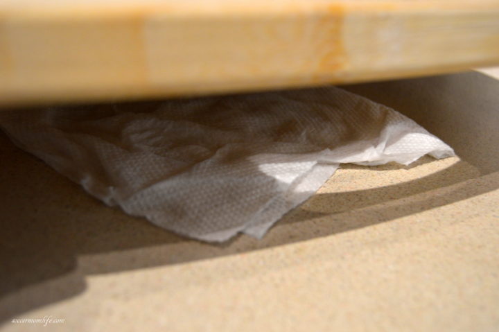 wet towel under cutting board